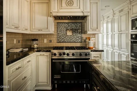 a living room with furniture and large windows