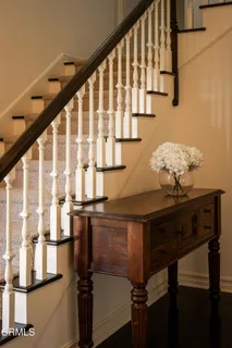 a bathroom with a granite countertop sink a mirror and shower