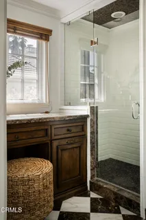 a bathroom with a sink a mirror and a shower