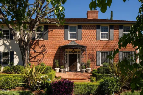 a view of hallway with wooden floor and stairs