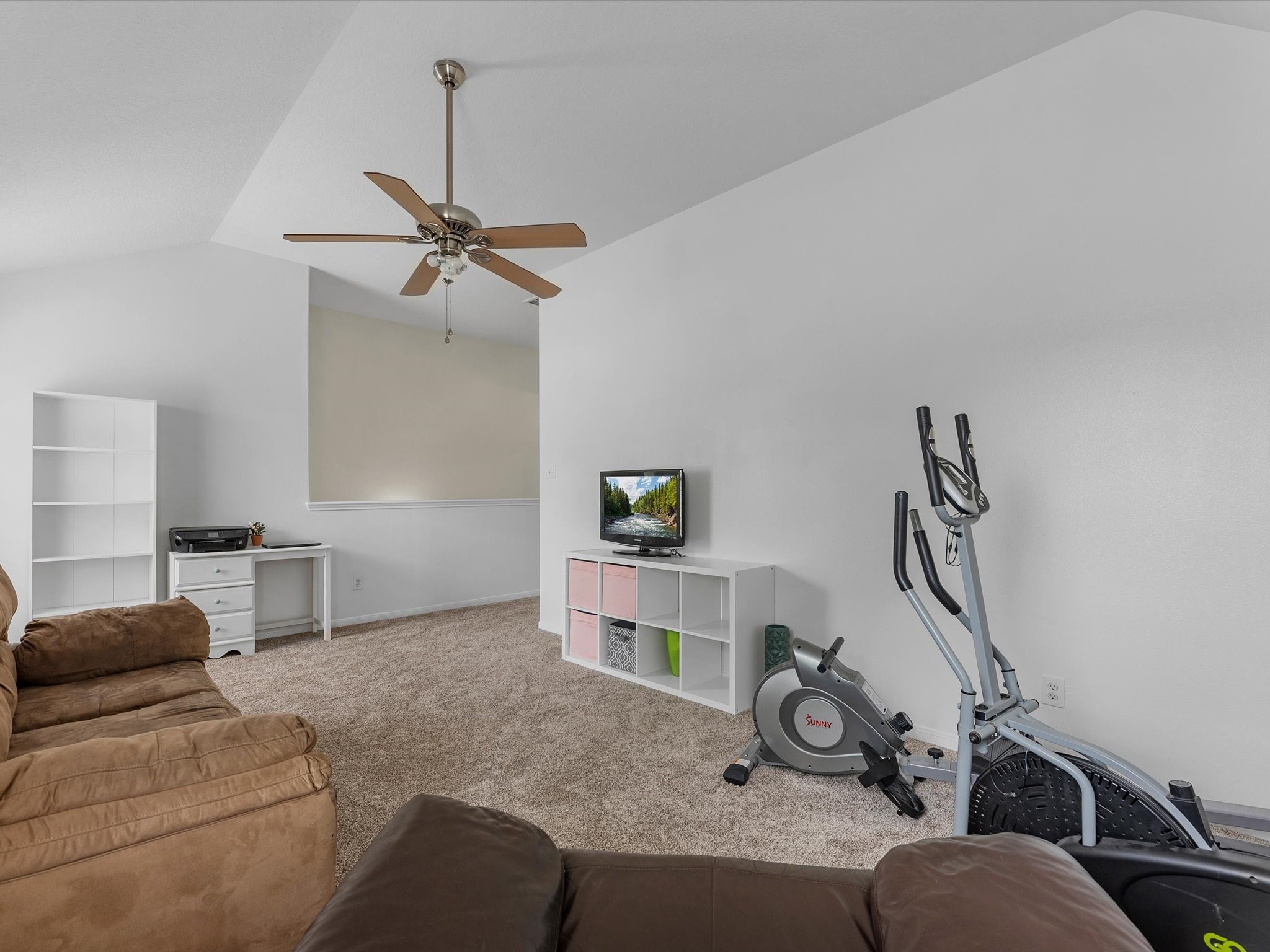 22422 Lamaster Lane Spring, TX 77373 - Photo 18 of 35 Spacious game room with carpeted flooring, featuring a ceiling fan. Ideal for relaxation, a second living area or a home gym setup.