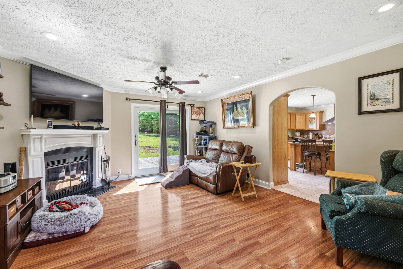 1637 Upper Standing Rock Road Dover, TN 37058 - Photo 6 of 57 a living room with furniture a flat screen tv and a fireplace