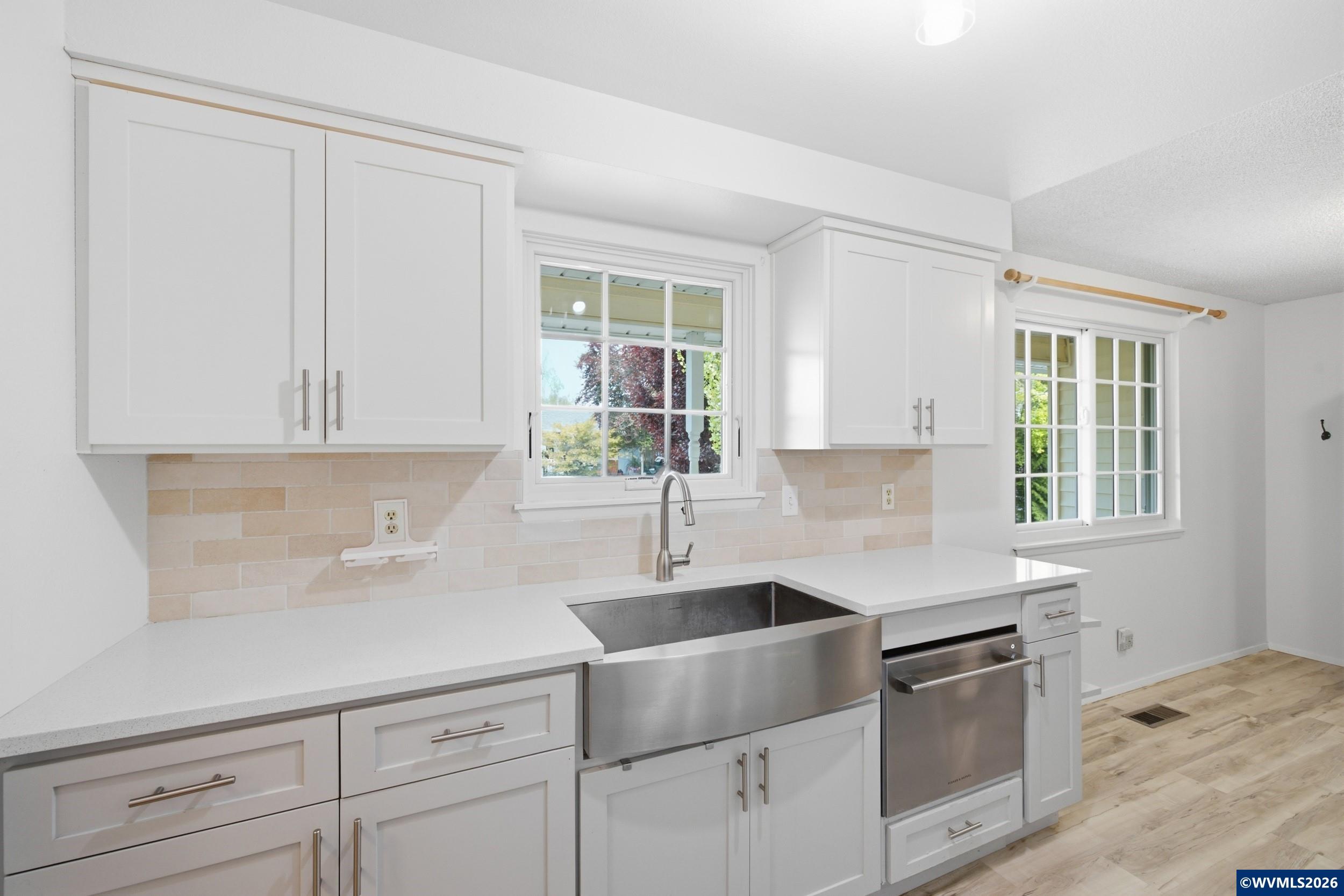 1213 Hemlock Loop Independence, OR 97351 - Photo 5 of 28 a kitchen with granite countertop white cabinets and window