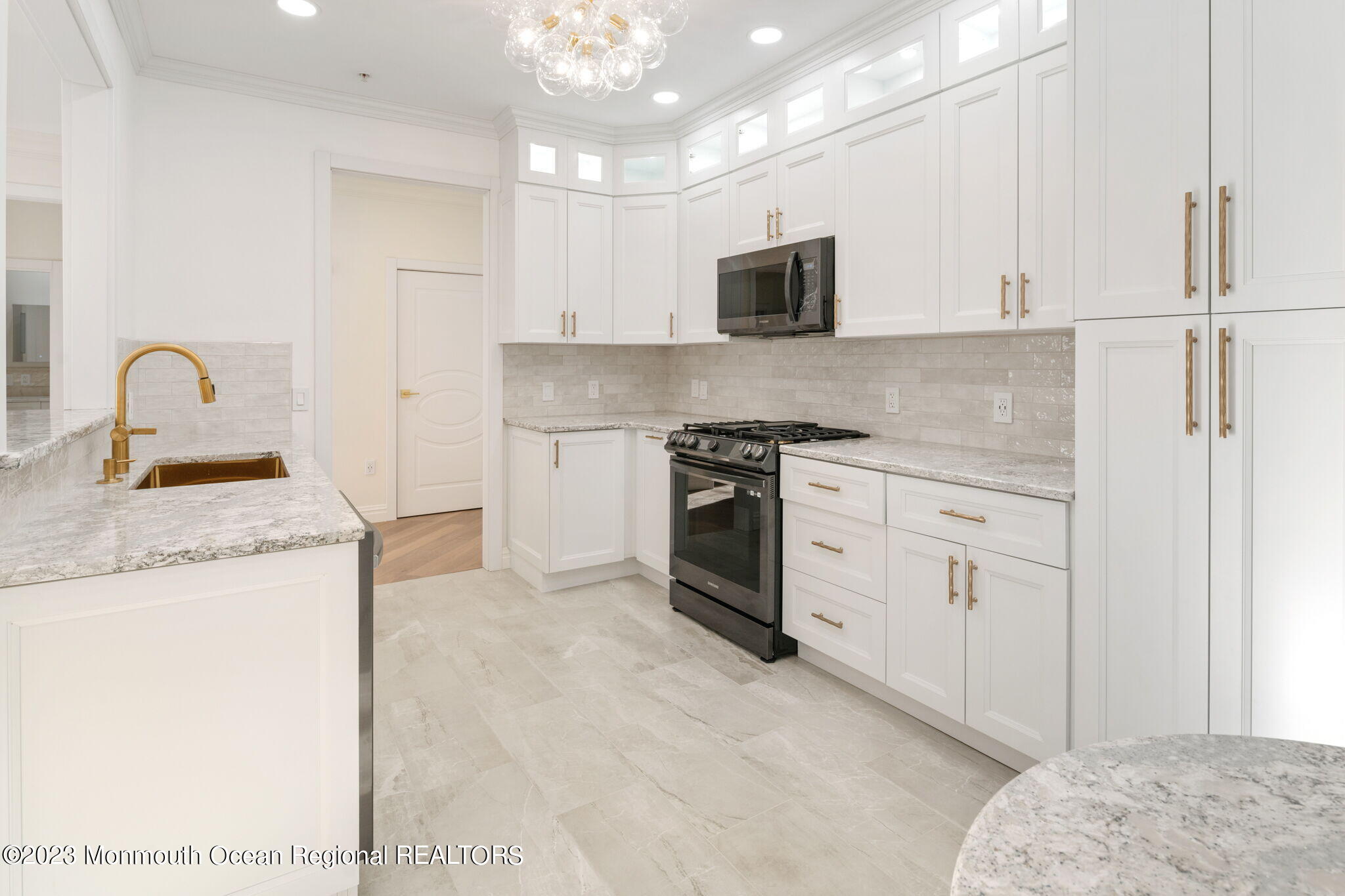 116 Potts Road Morganville, NJ 07751 - Photo 13 of 34 a kitchen with granite countertop white cabinets and white appliances