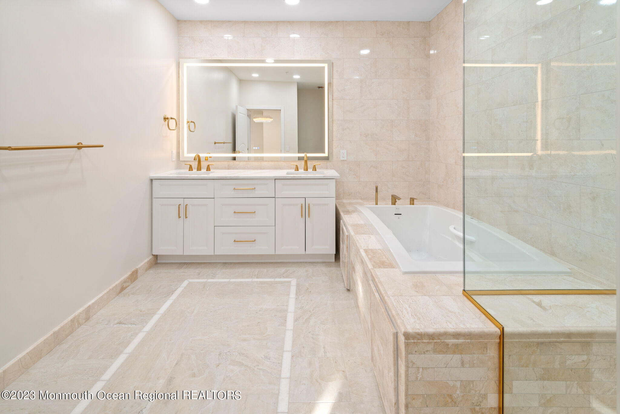 116 Potts Road Morganville, NJ 07751 - Photo 30 of 34 a spacious bathroom with a double vanity sink a mirror and a bathtub