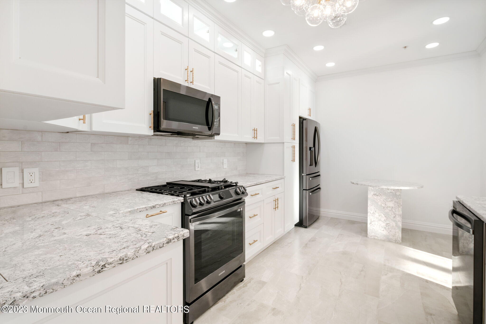 116 Potts Road Morganville, NJ 07751 - Photo 6 of 34 a kitchen with a stove and a microwave