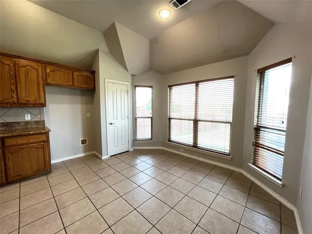 a view of a kitchen with windows and kitchen area