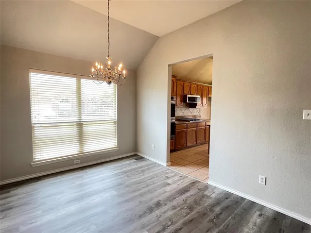 a view of a kitchen with a dishwasher cabinets and a large window