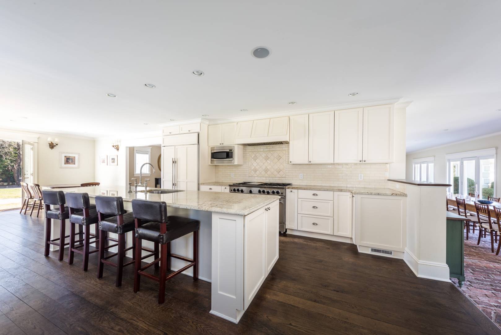 23 Basket Neck Lane Remsenburg, NY 11960 - Photo 9 of 17 a kitchen with white cabinets and wooden floor