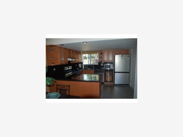 504 Monterey Road, Unit O Pacifica, CA 94044 - Photo 3 of 9 a kitchen with stainless steel appliances kitchen island sink refrigerator and stove