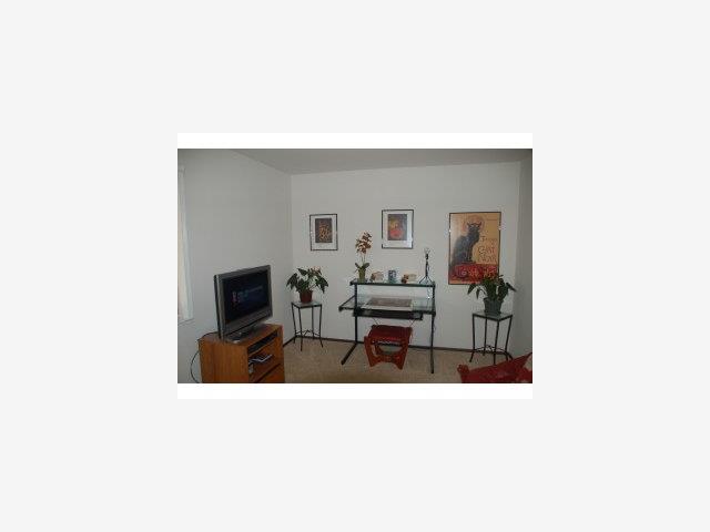 504 Monterey Road, Unit O Pacifica, CA 94044 - Photo 7 of 9 a living room with furniture and a flat screen tv