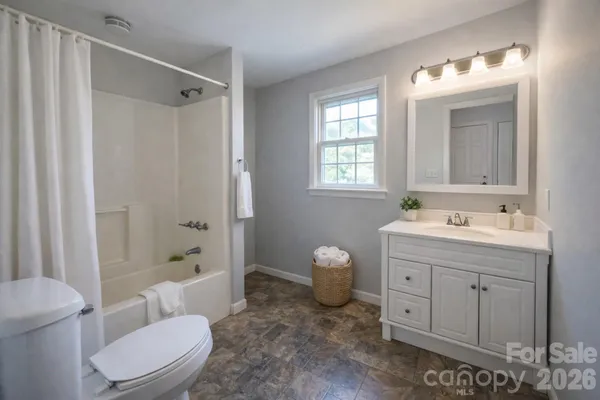 a spacious bathroom with a sink toilet and shower