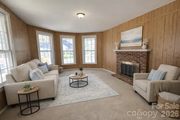 a living room with furniture fireplace and window