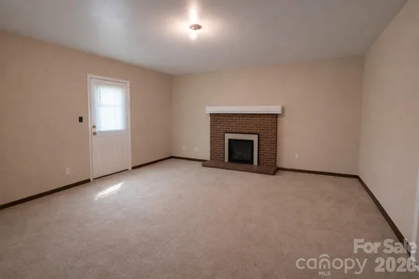 an empty room with a fireplace