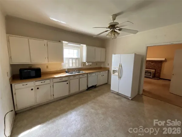 a kitchen with refrigerator and window