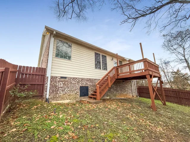 a view of a house with a backyard