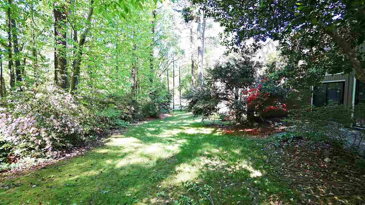 4301 Sun Belt Place Raleigh, NC 27613 - Photo 22 of 23 Park-like Setting complete with Mature Trees and Flowering Landscaping creates a Backyard Oasis View