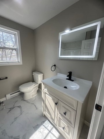 15-17 Otis Court, Unit 15 Springfield, MA 01119 - Photo 12 of 16 a bathroom with a toilet sink and mirror