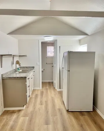 a kitchen with a refrigerator and a sink