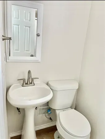 a bathroom with a sink a toilet and mirror