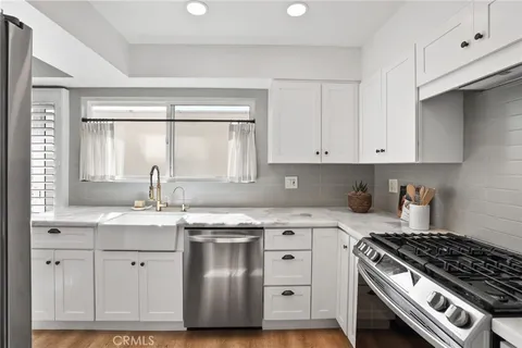 a kitchen with a sink and a wooden cabinets