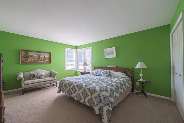 a bedroom with a bed and a chair