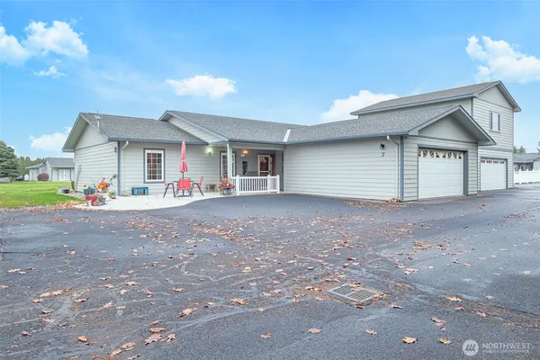 a view of a house with a backyard and a garage