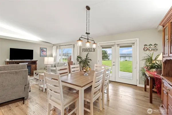a view of a dining room with furniture window and wooden floor