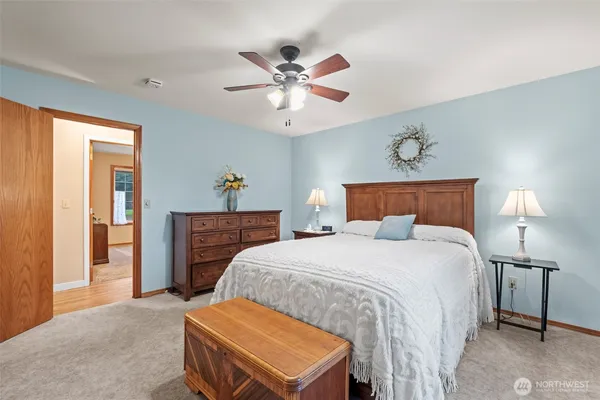 a bedroom with a bed and a chandelier