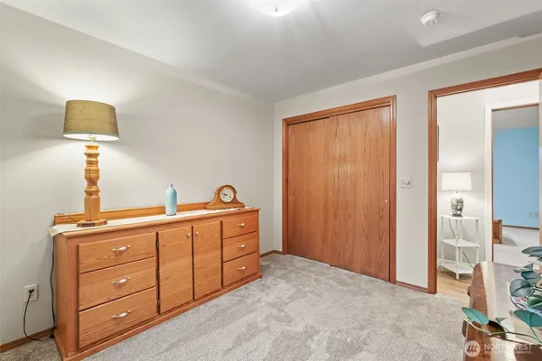 a room with a bed and a night stand
