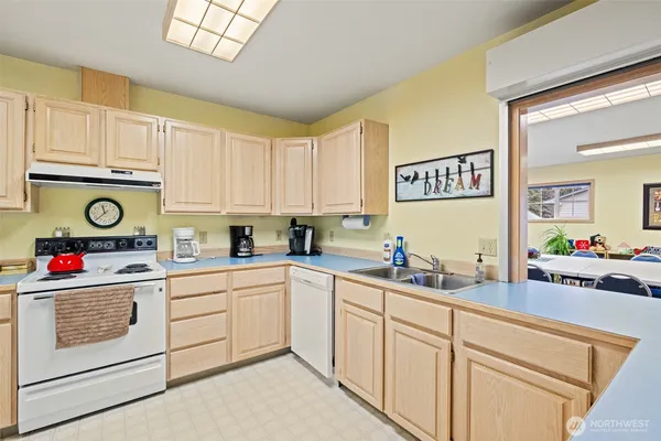 a kitchen with cabinets a sink and appliances