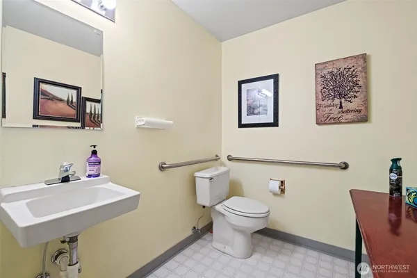 a bathroom with a toilet sink and mirror