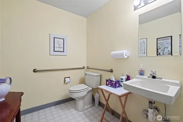 a bathroom with a sink mirror and toilet
