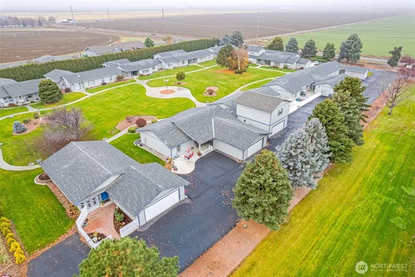 an aerial view of a house with a swimming pool yard and outdoor seating