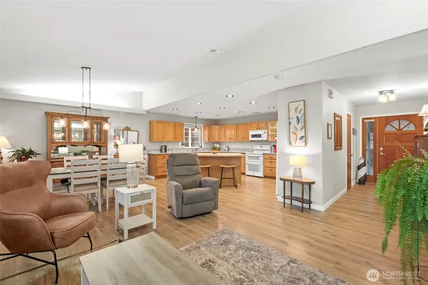 a living room with lots of furniture and view of kitchen