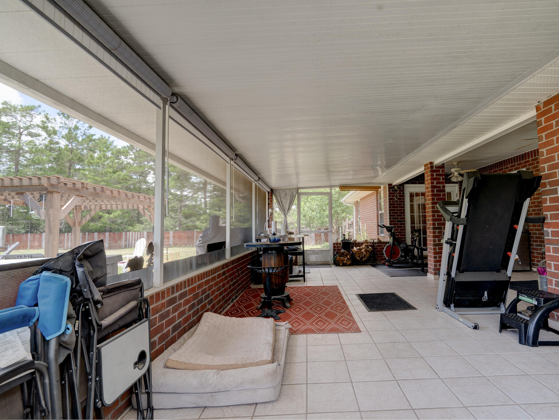 4173 Big Buck Trail Crestview, FL 32539 - Photo 23 of 38 a living room with furniture floor to ceiling window and a table