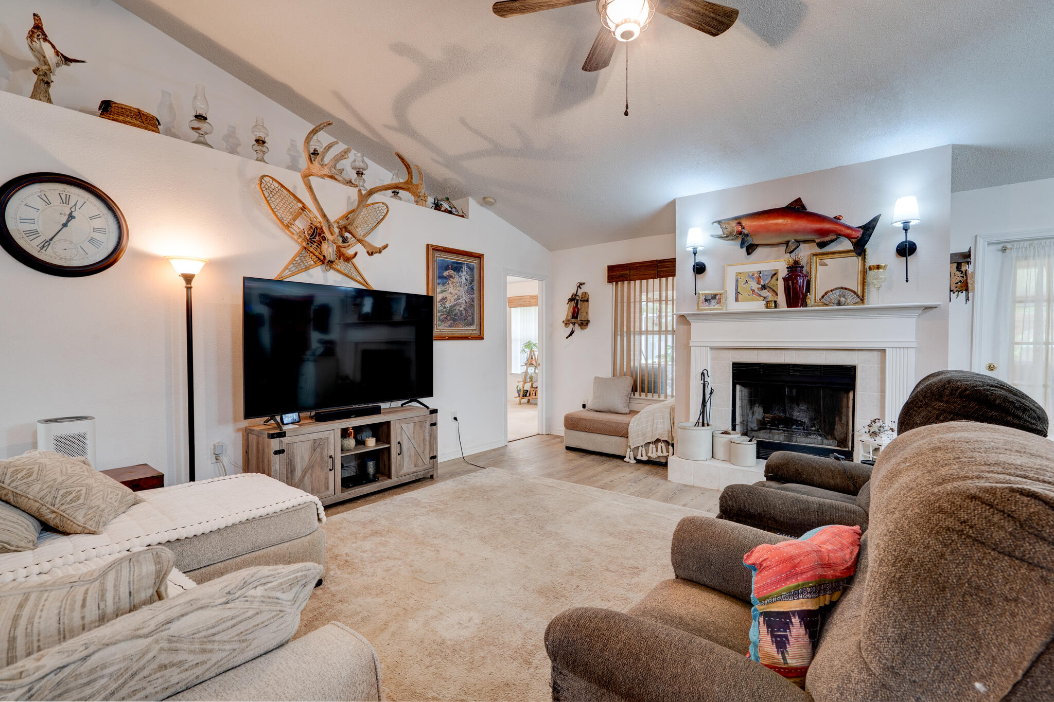 4173 Big Buck Trail Crestview, FL 32539 - Photo 6 of 38 a living room with furniture a flat screen tv and a fireplace