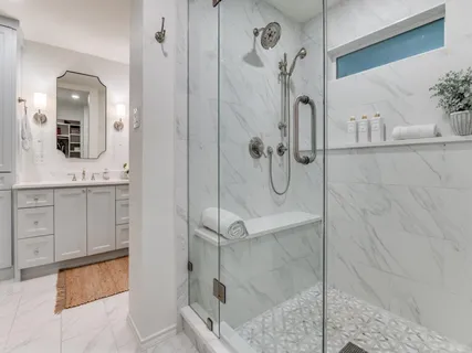 a spacious bedroom with a bed and a chandelier