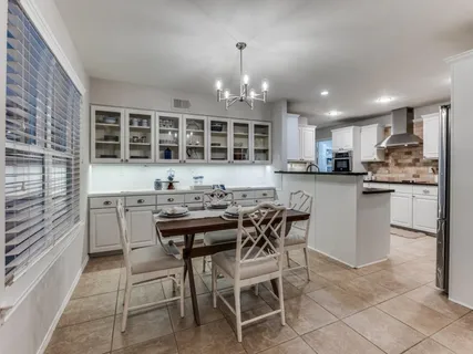 a kitchen with kitchen island granite countertop wooden cabinets and counter space