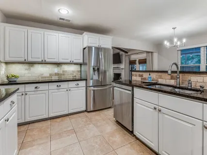 a kitchen with granite countertop cabinets and steel stainless steel appliances