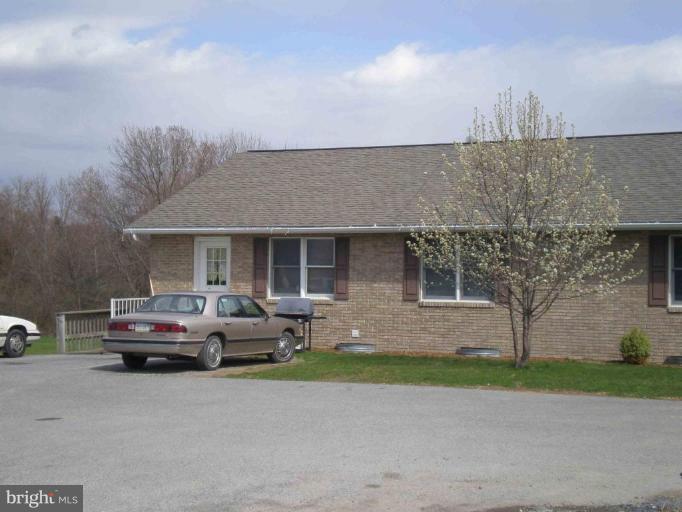 9130 Letzburg Road Mercersburg, PA 17236 - Photo 2 of 8 a car parked in front of a house