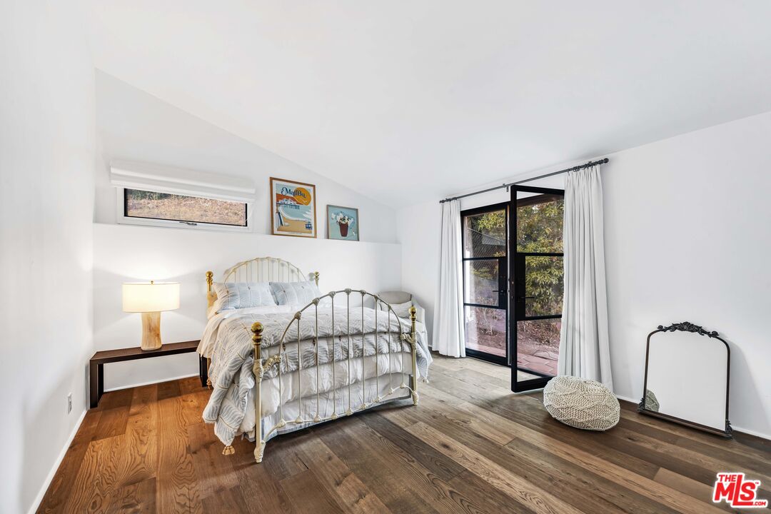 2382 Live Oak Meadows Road Malibu, CA 90265 - Photo 14 of 20 a bedroom with a bed and wooden floor