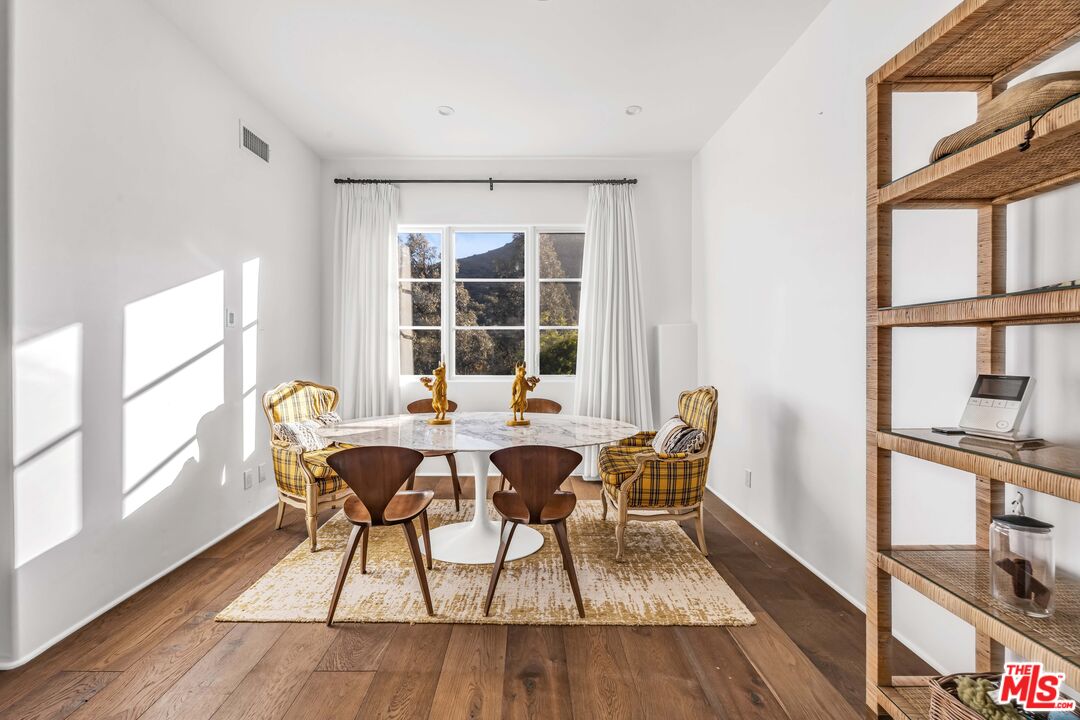 2382 Live Oak Meadows Road Malibu, CA 90265 - Photo 8 of 20 a dining room with furniture and wooden floor
