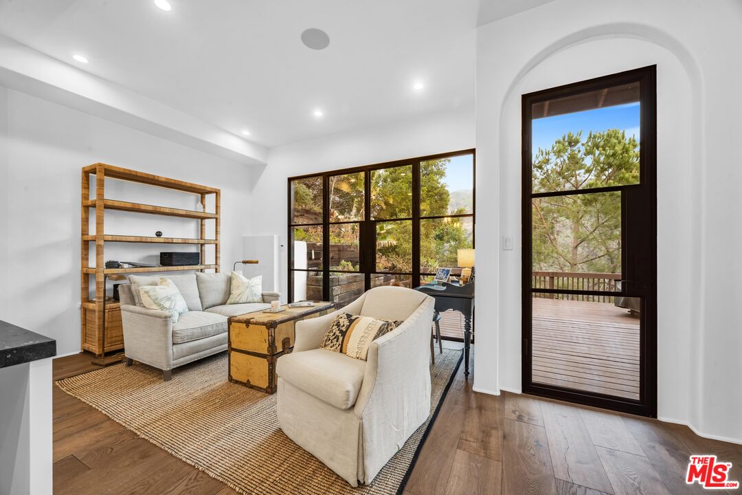 2382 Live Oak Meadows Road Malibu, CA 90265 - Photo 9 of 20 a living room with furniture and a large window