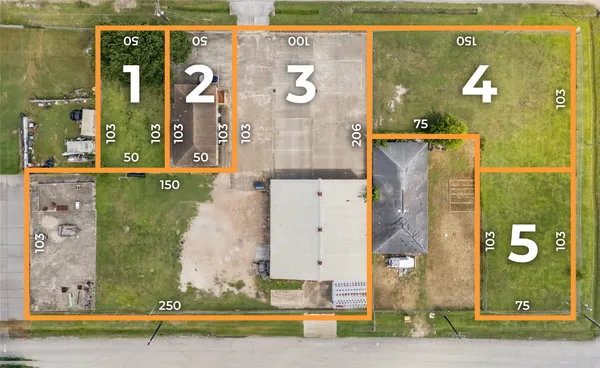 an aerial view of a residential building with outdoor space and parking
