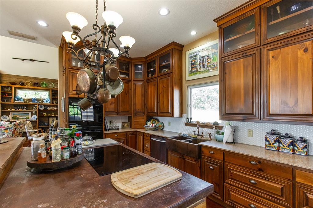 1775 Sunset Mountain Road Lipan, TX 76462 - Photo 12 of 34 a kitchen with a sink a chandelier and living room view