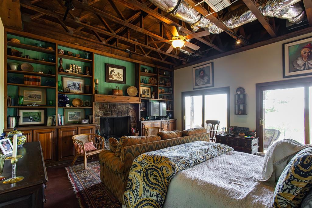 1775 Sunset Mountain Road Lipan, TX 76462 - Photo 13 of 34 a bed room with furniture and a fireplace