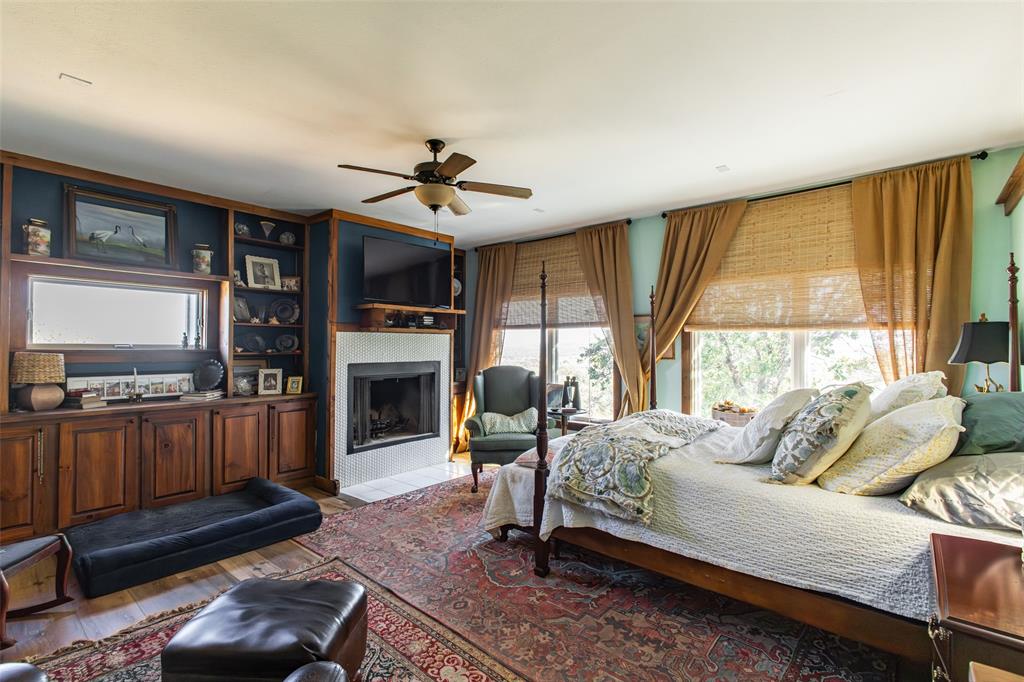 1775 Sunset Mountain Road Lipan, TX 76462 - Photo 16 of 34 a living room with furniture fireplace and flat screen tv