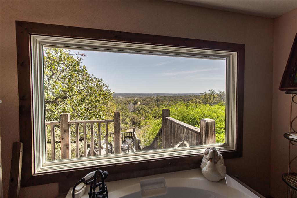 1775 Sunset Mountain Road Lipan, TX 76462 - Photo 18 of 34 a view of a balcony with furniture