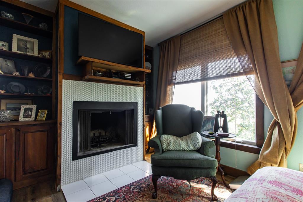 1775 Sunset Mountain Road Lipan, TX 76462 - Photo 23 of 34 a living room with furniture and a fireplace